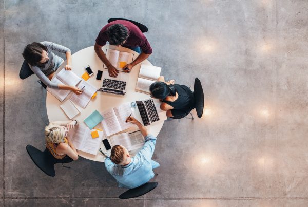Top,View,Of,Group,Of,Students,Sitting,Together,At,Table.