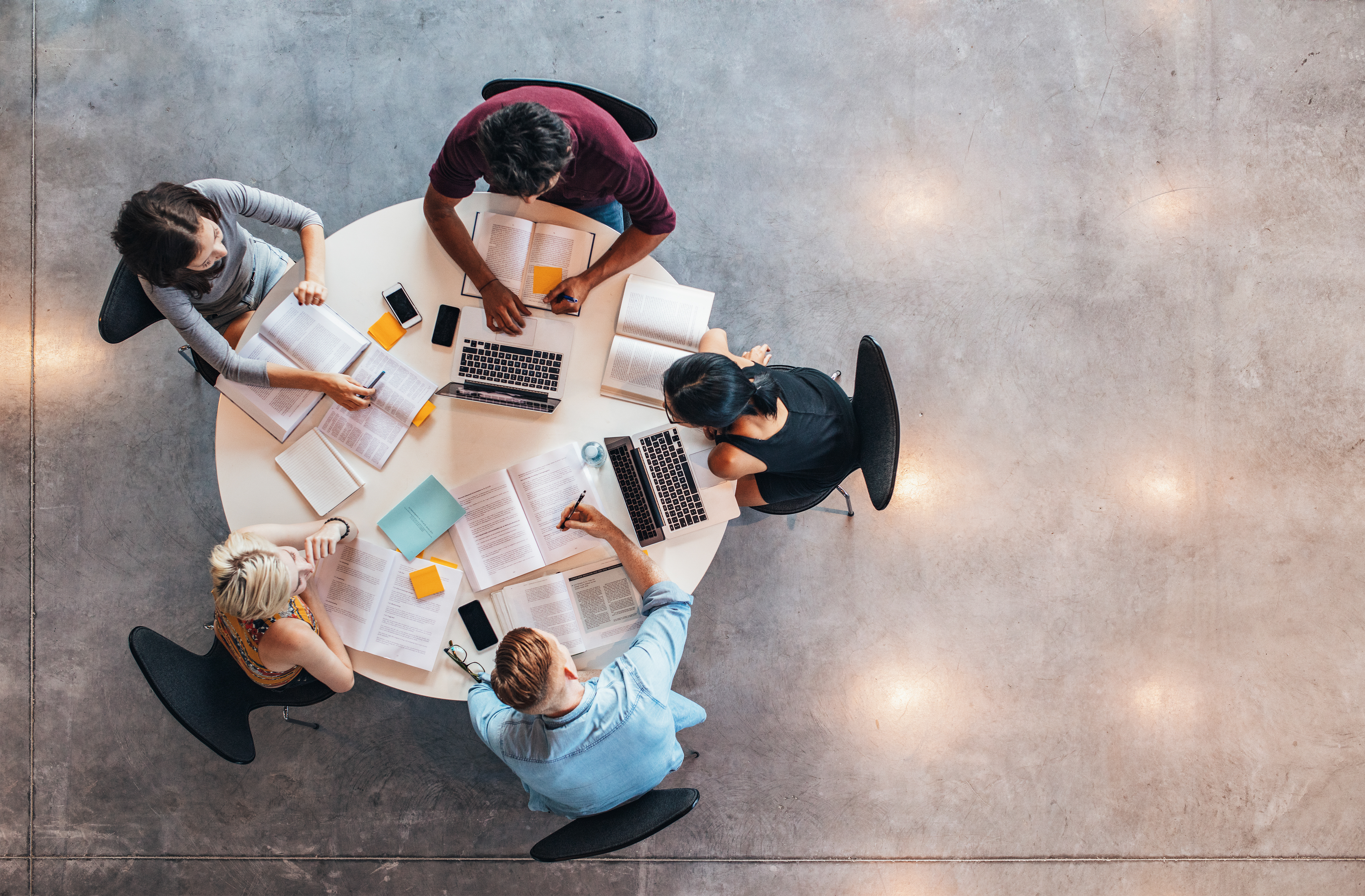 Top,View,Of,Group,Of,Students,Sitting,Together,At,Table.